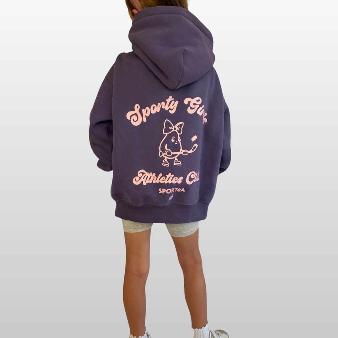 Person wearing a purple hoodie with text and graphics on the back, standing against a white background