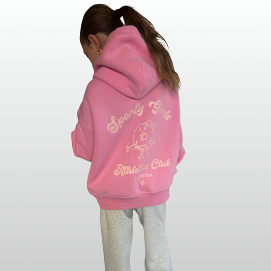 Person wearing a pink hoodie with text and graphics on the back, standing against a white background